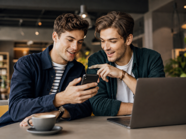 Two friends managing their connection on a phone Two friends managing their connection on a phone